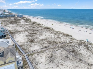 A beach resort with a boardwalk, beach, and ocean view.