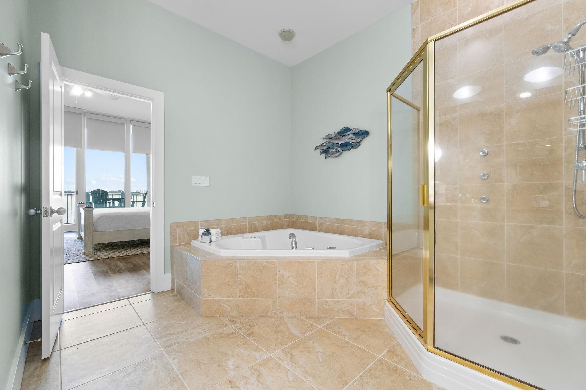 A bathroom with a bathtub, shower, and a glass-enclosed shower area.