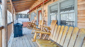 A wooden deck with Adirondack chairs and a grill. - Quaint Dahlonega Cabin w/ Cavenders Creek Access! (Dahlonega)