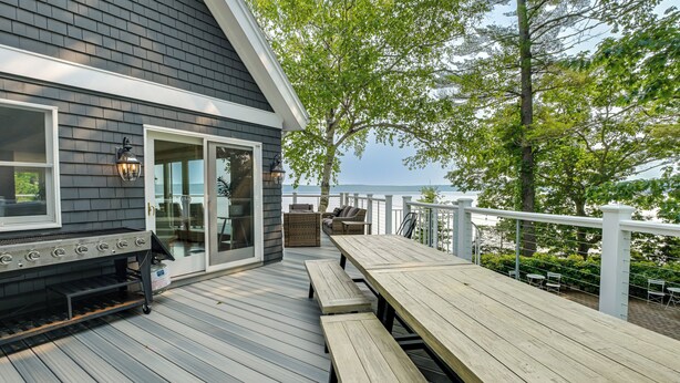 A deck with a grill, outdoor seating, and a view of the water. - ‘The Beachhouse’ Retreat w/ Prescot Bay Views! (Stockton Springs)