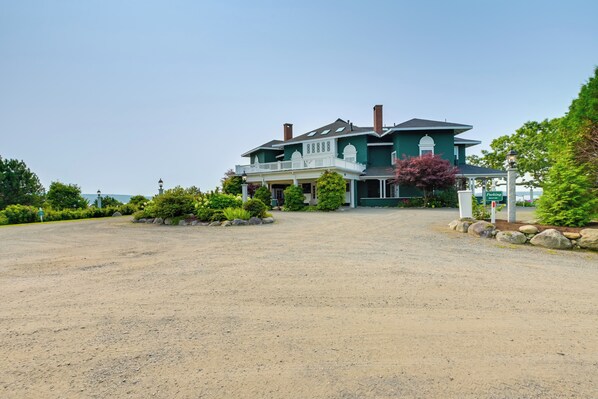 A large, two-story house with a porch and a driveway.