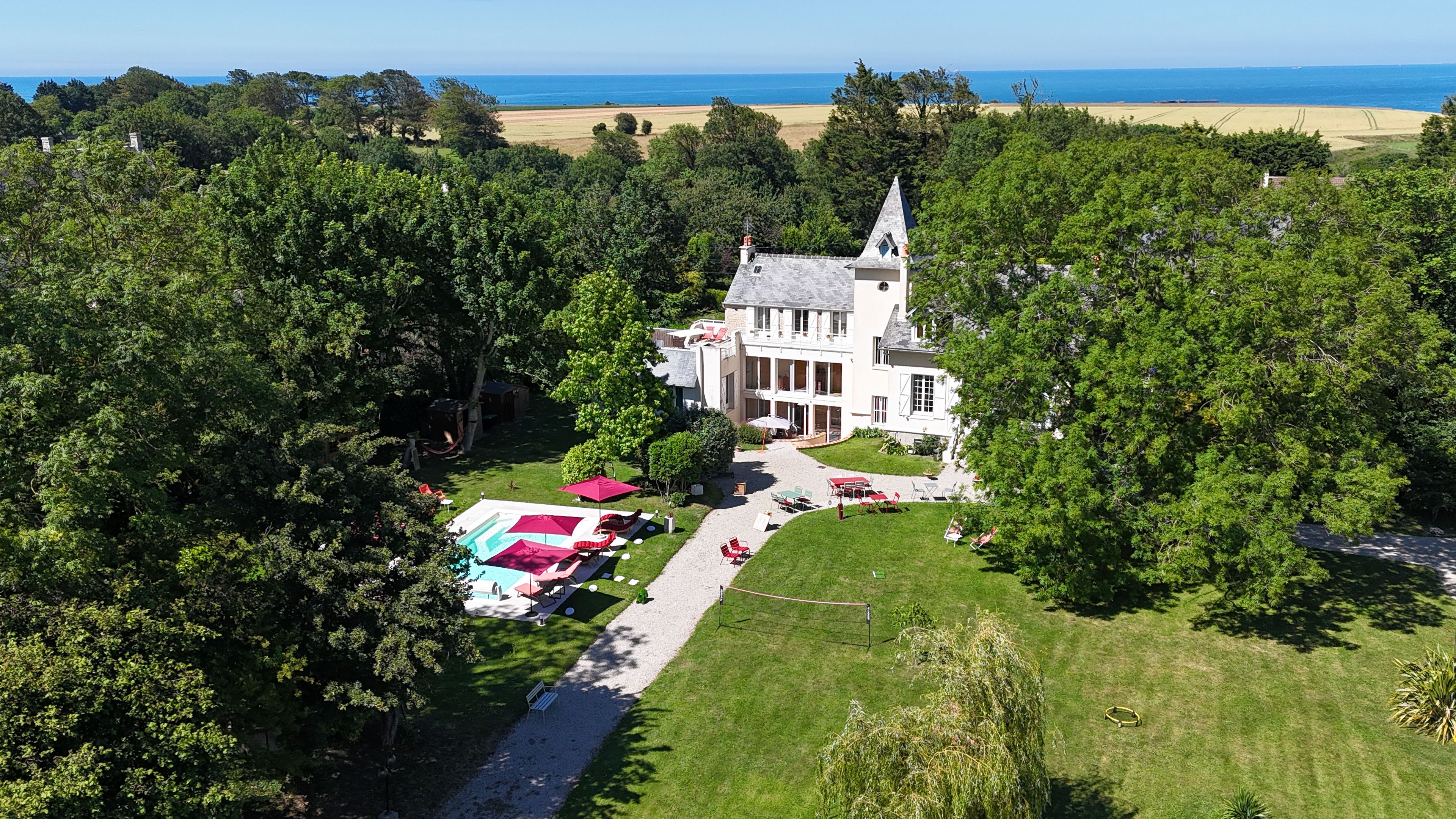 A large estate with a prominent building, a swimming pool, and a well-maintained lawn.