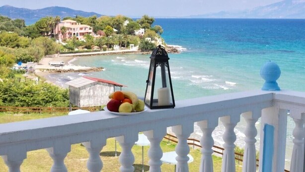A balcony with a view of the sea, a lantern, and a plate of fruit. - CLEAR HORIZON (Zakynthos)