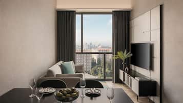 Departamento Deluxe, 1 cama Queen size | Sala de estar | Televisión LED de 43 pulgadas con canales por cable