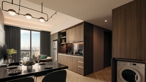 A modern kitchen with a built-in washer and dryer, a dining area with a table set for two, and a large window offering a city view. - Quincy House Singapore  (Singapore)