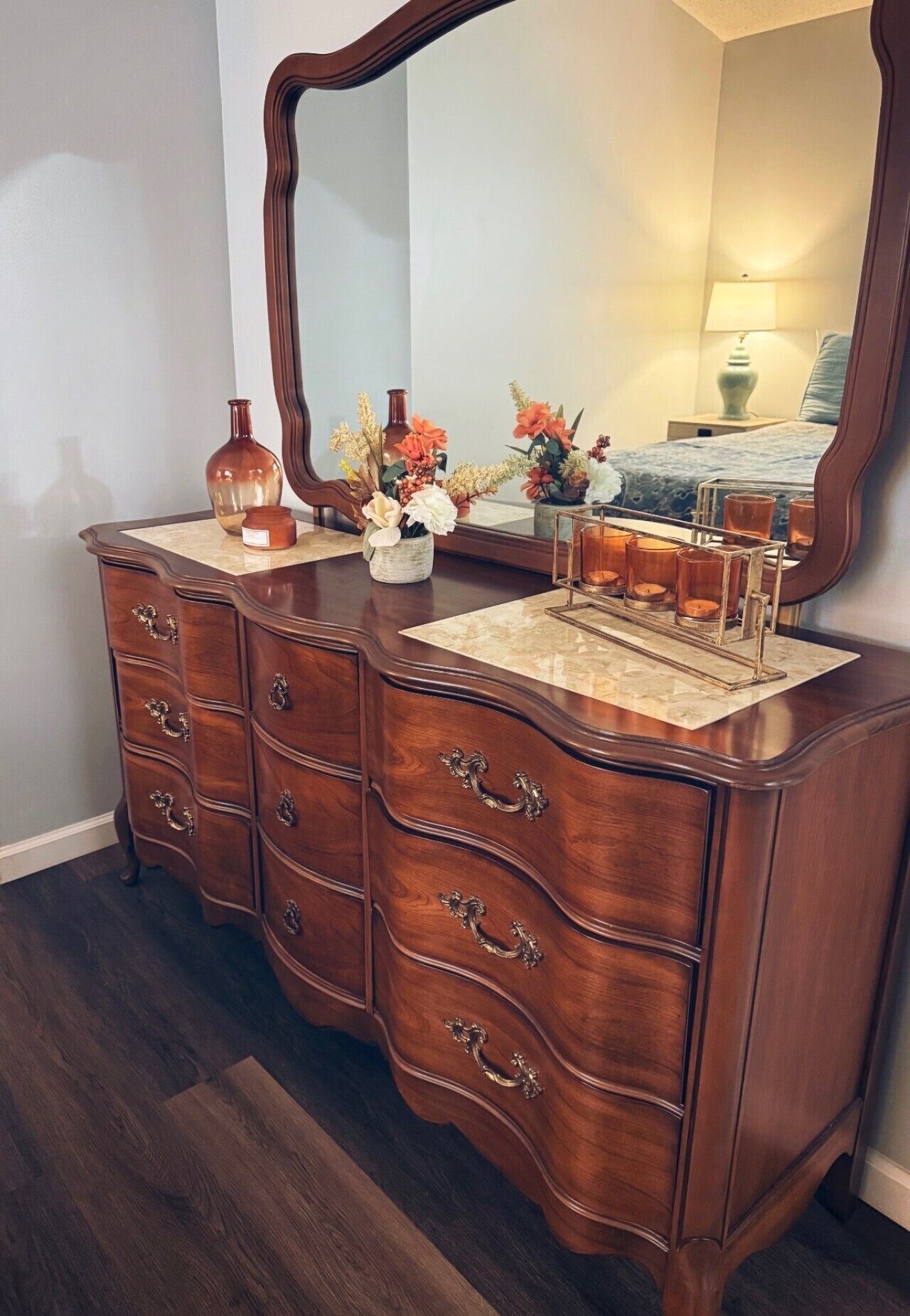 Une commode en bois avec de nombreux tiroirs et un miroir.
