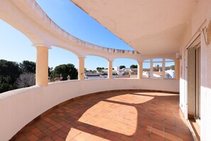 Relax on the covered terrace with a view of the surrounding landscape.