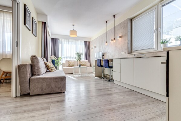 Comfort Apartment | Living area | 37-inch flat-screen TV with digital channels