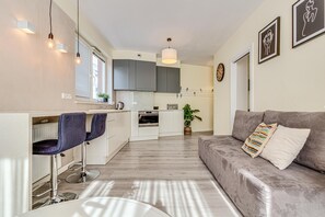 Comfort Apartment | Living area | 37-inch flat-screen TV with digital channels