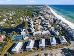 An aerial view of a coastal resort with multiple buildings, a beach, and a lake. - Newly Renovated | Beach | Pickleball | Pool (Santa Rosa Beach)