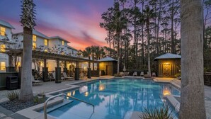A pool area with a 3ft depth marker, surrounded by lounge chairs and a covered patio. - New 4BR Home | Pool | Elevator | 8 Bikes (Rosemary Beach)