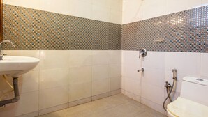 A bathroom with a sink, toilet, and shower. - The Baga Village (Baga)