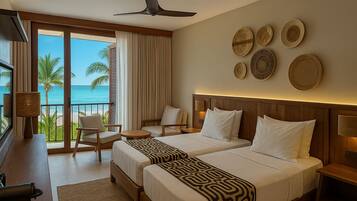 A hotel room with two beds, a desk, a chair, and a view of the ocean.