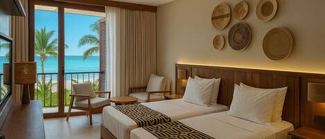 A hotel room with two beds, a desk, a chair, and a view of the ocean.