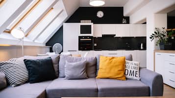 Deluxe Apartment | Living room | 37-inch flat-screen TV with digital channels