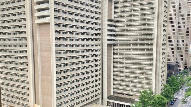 A high-rise building with a grid-like facade, multiple balconies, and a central dome structure. - FIFA 2026 Walk to Stadium | 1BR Unit 8K ATL (Atlanta)