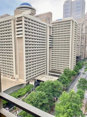 A high-rise building with a grid-like facade, multiple balconies, and a central dome structure. - FIFA 2026 Walk to Stadium | 1BR Unit 8K ATL (Atlanta)