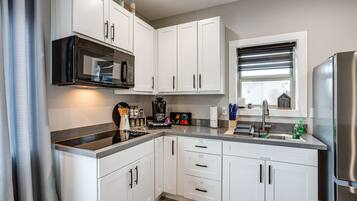 Microwave, coffee/tea maker, cookware/dishes/utensils, spices