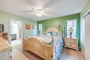 A bedroom with a wooden bed, a nightstand, a dresser, and a ceiling fan. - Marco Island Home w/ Private Pool & Water Views! (Marco Island)