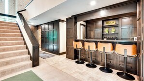 A bar area with wooden stools and a sign that reads "BUCK". - Heated Pool: Tropical Townhome in Wheat Ridge (Wheat Ridge)