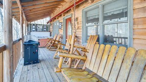 A wooden deck with Adirondack chairs and a grill. - Quaint Dahlonega Cabin w/ Cavenders Creek Access! (Dahlonega)