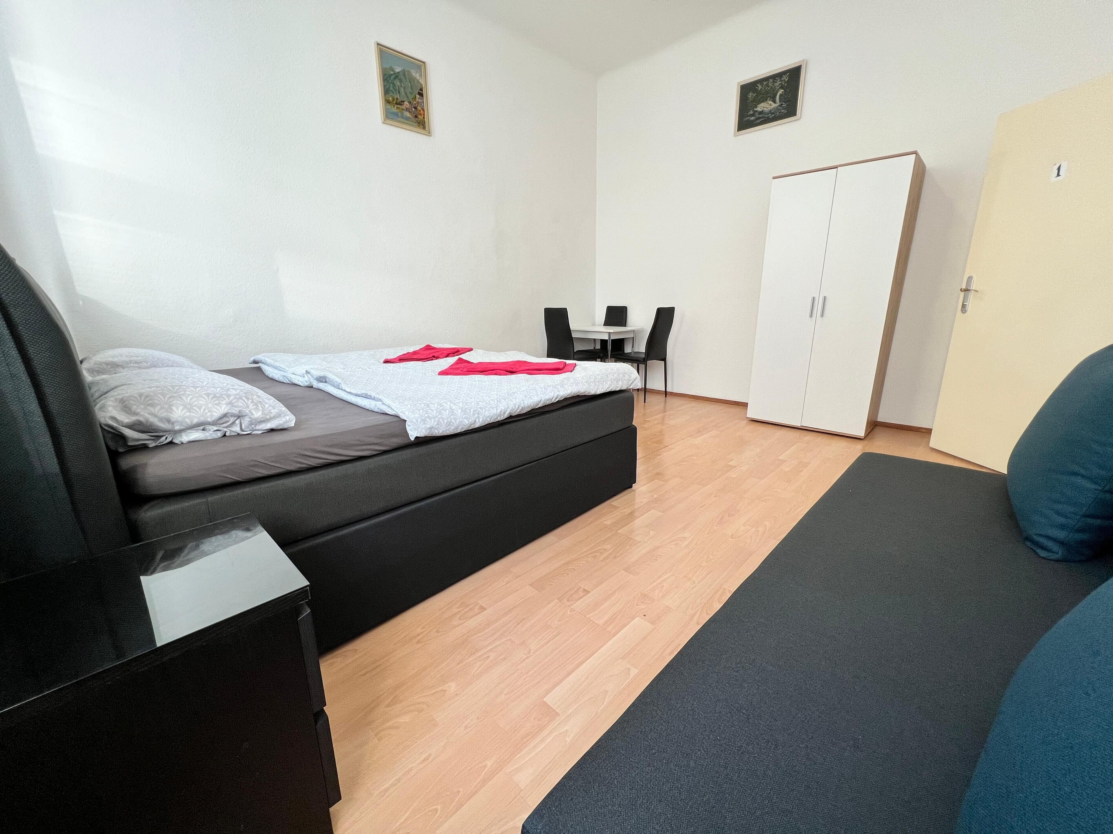 Una camera da letto moderna con un letto, una scrivania e un armadio.