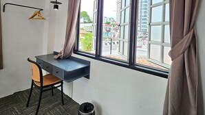 A room with a desk, chair, and a large window with curtains. - Luna Hotel by Moonknight (George Town)