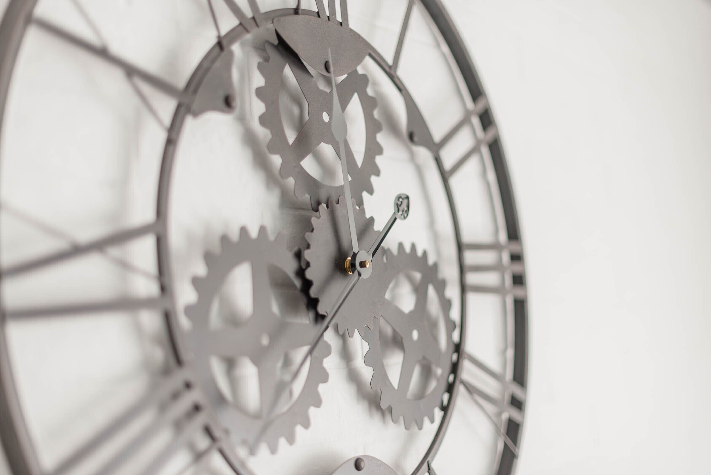 A close-up of a clock with interlocking gears and Roman numerals.