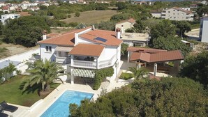A residential property with a swimming pool, multiple buildings, and surrounding greenery. - Comfortable Villa Ajda with sea view and heated pool (Pula)