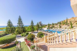 A resort with a pool, outdoor seating, and a view of the sea. - Villa Vasilissa - Five Bedroom Villa, Sleeps 10 (Agia Marina Chrysochous)