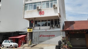 A multi-story building with signage reading "WISMA OH KONGSI" and the number "60" prominently displayed. - The 60 (George Town)