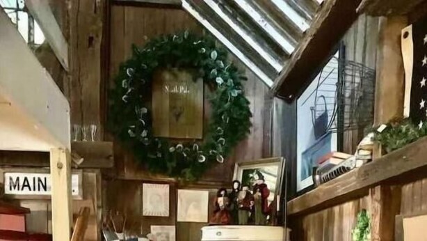 A wooden staircase with a sign reading "MAIN" above it. - Inn the Barn (Conestoga)
