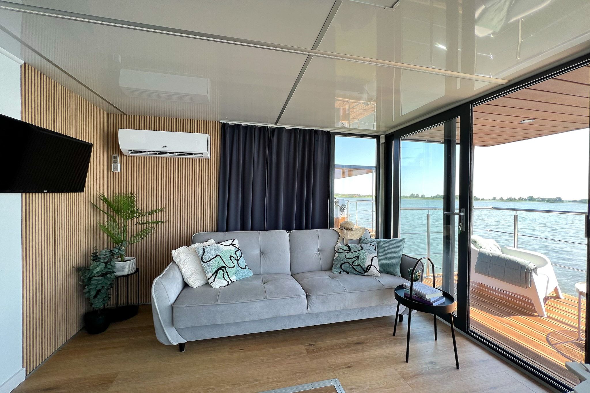 A modern living area with a sofa, a small table, and a potted plant.