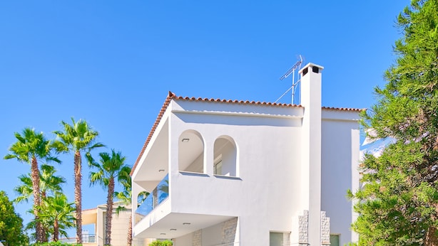 A modern pool area with lounge chairs and a hot tub, surrounded by a well-maintained lawn and palm trees. - Luxury Villa with Pool,BBQ and Garden Vouliagmeni
 (Voula)