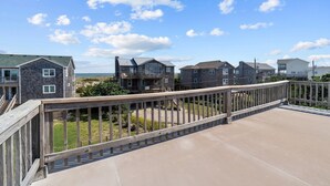 A coastal residential area with a wooden deck overlooking a sandy beach. - Ocean View, Semi-Oceanfront, Screened In Porch, Beach Access (Avon)