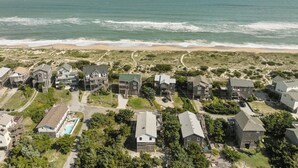 A coastal residential area with houses, a beach, and ocean views. - Ocean View, Semi-Oceanfront, Screened In Porch, Beach Access (Avon)