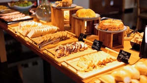 A buffet with various food items including sliced meats, cheeses, and pastries. - Vert Hotel Spa (Itatiaia)