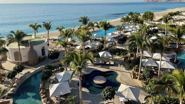 A resort with a pool, palm trees, and a beach view. - Amazing 3-bedroom condo with pool, fitness room, in phenomenal Chileno Bay, Cabo (San José del Cabo)