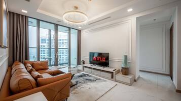 Deluxe Apartment, 3 Bedrooms, Balcony, City View | Living area | 42-inch Smart TV with cable channels
