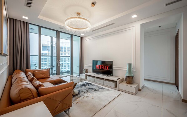 Deluxe Apartment, 3 Bedrooms, Balcony, City View | Living area | 42-inch Smart TV with cable channels