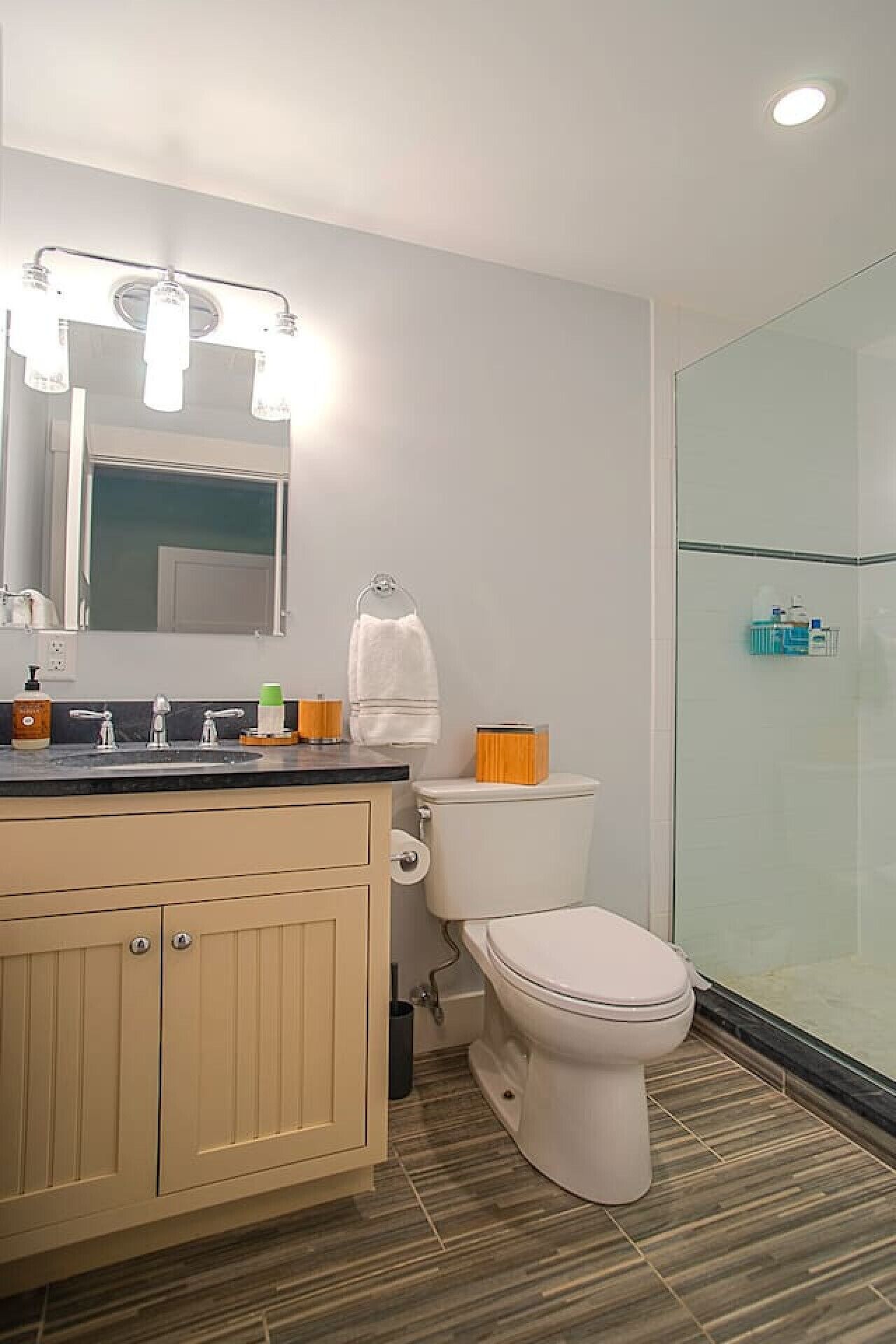 Une salle de bain avec des toilettes, un lavabo et un miroir.