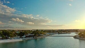 A coastal resort area with a marina, palm trees, and a clear sky. - Villa Paradise Punta Cana (Punta Cana)