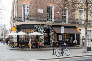 A corner building with a coffee shop on the ground floor.