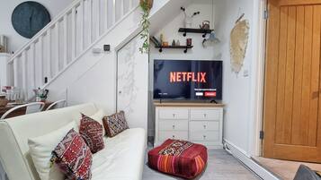 Family Apartment | Living area | 50-inch Smart TV with satellite channels