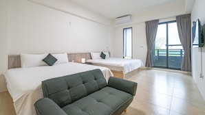 A hotel room with two beds, a sofa, and a balcony with curtains. - YUTAI VILLA (Wujie)