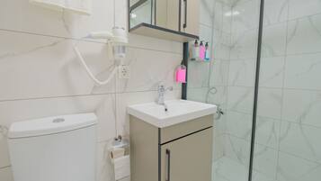 Shower, hair dryer, slippers, towels