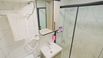 Shower, hair dryer, slippers, towels