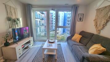 City Apartment | Living area | 50-inch Smart TV with digital channels