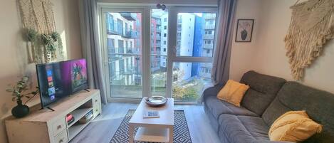 City Apartment | Living area | 50-inch Smart TV with digital channels