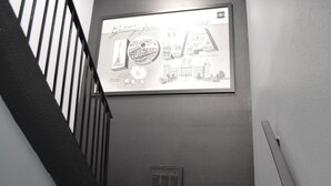 A framed sign with "Greetings from Iowa" and a cityscape.